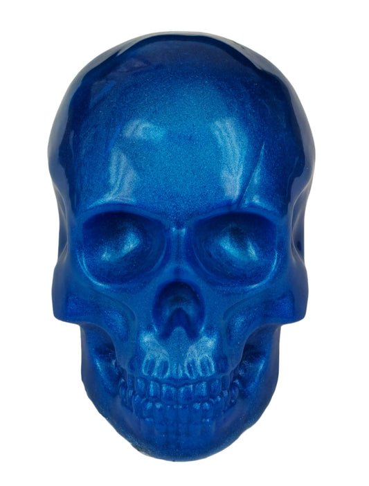A blue epoxy skull sculpture with a pearlized effect. Front