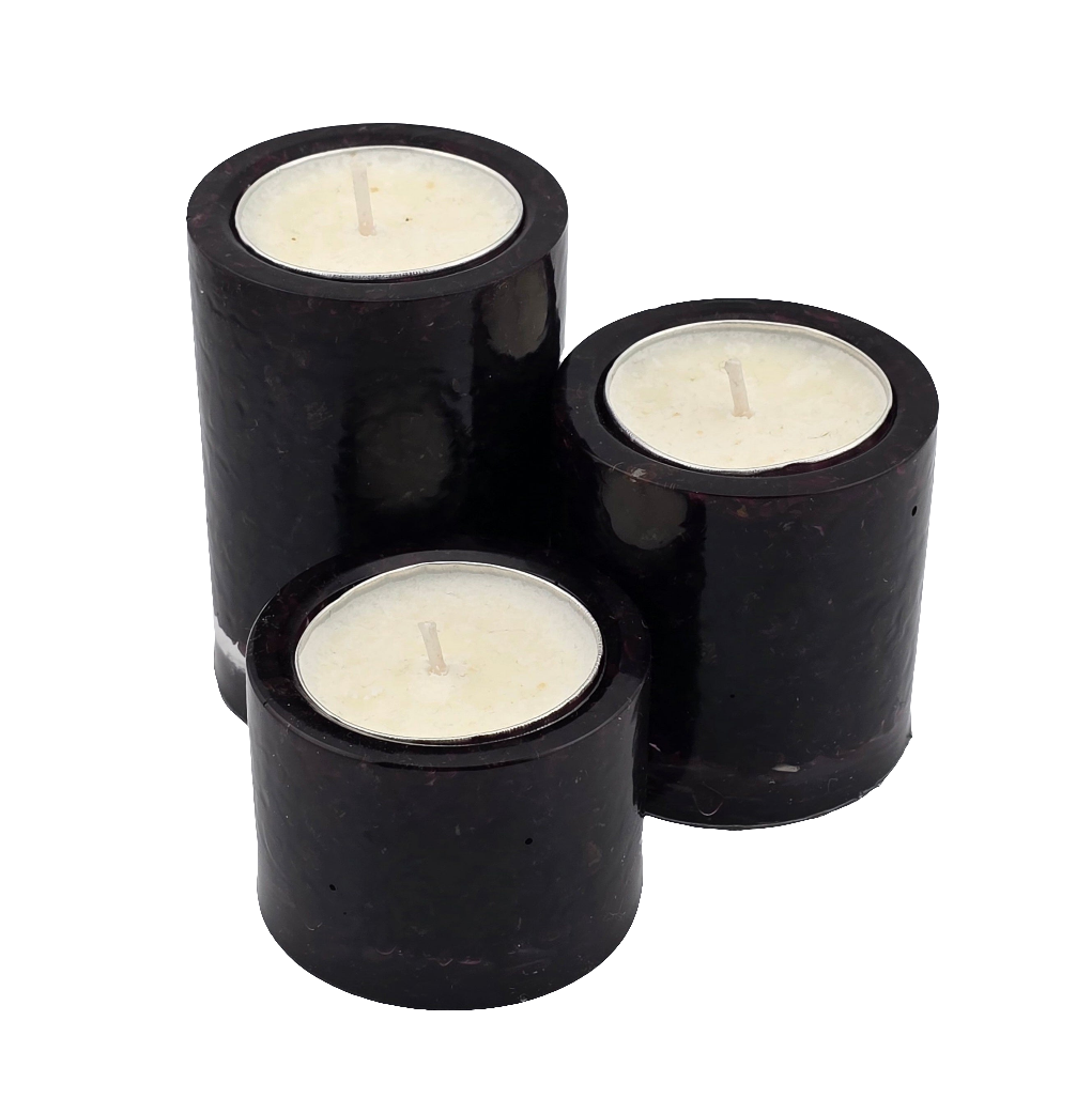 Three garnet tea light candle holders with candles on a white background