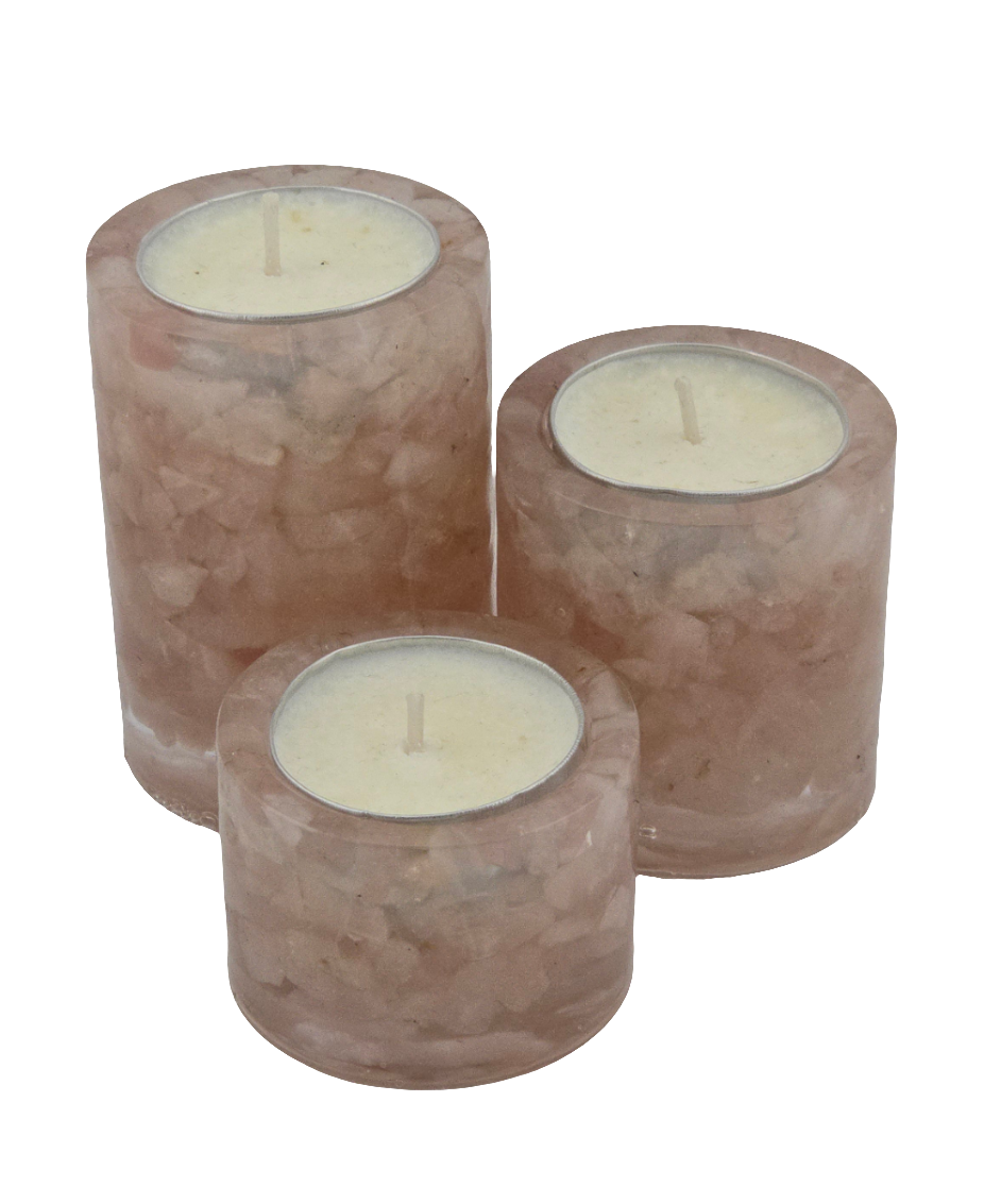 Three Rose Quartz gemstone tea light candle holders with candles on a white background