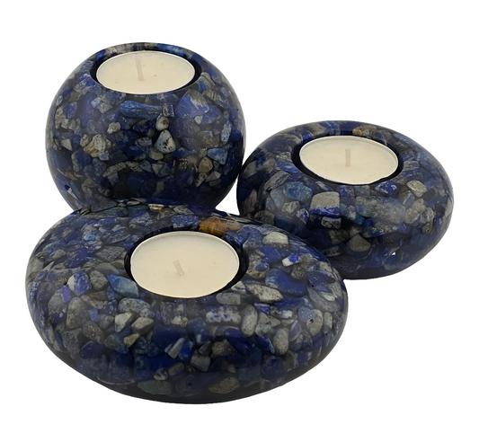 Three blue and gray Lapis Lazuli tea light candle holders with candles on a white background