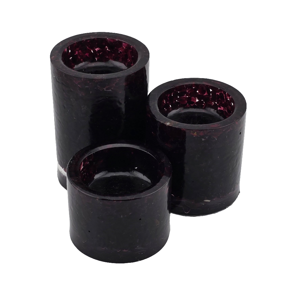 Three garnet cylindrical tea light candle holders on a white background