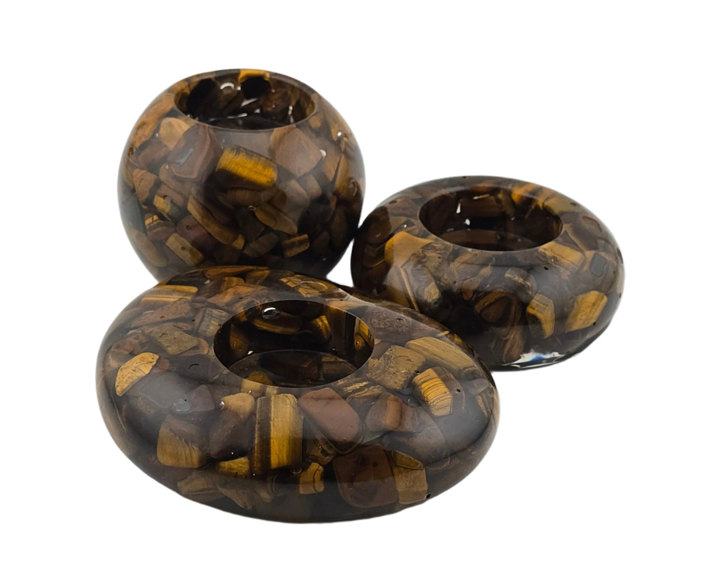 Three tiger eye stone candle holders on a white background