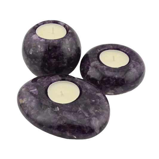 Three purple stone candle holders with candles inside on a white background
