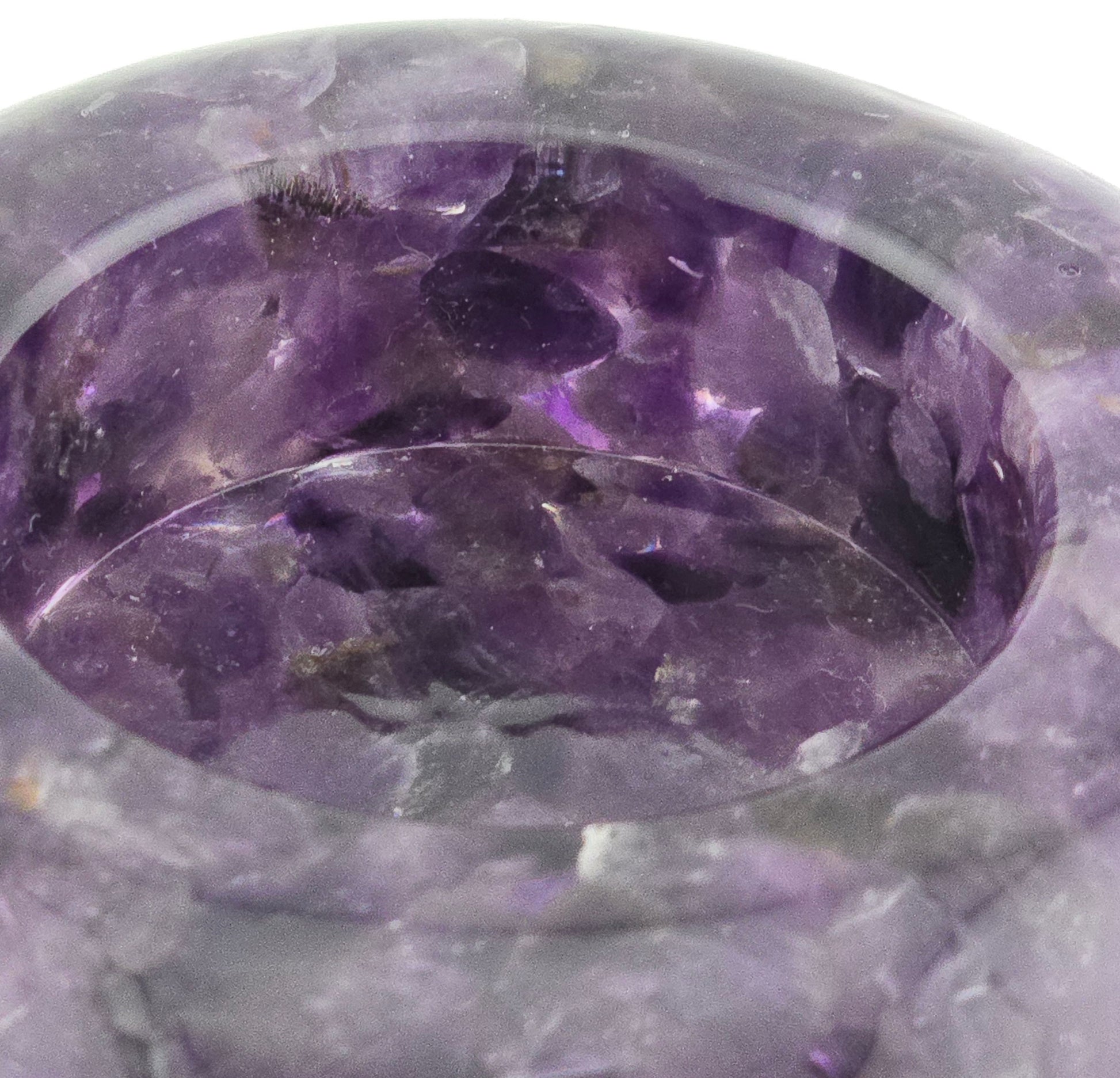 Close-up of a purple crystal bowl with visible crystals inside