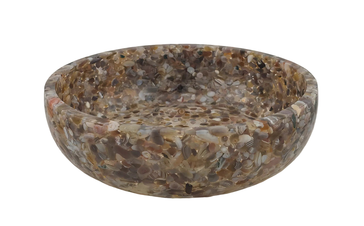 A round resin bowl filled with embedded Botswana Agate semi-precious stone chips in earthy brown, beige, gray, and white tones, photographed on a plain light background.
